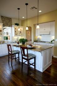 Full overlay white cabinets are warmed up with a light wood kitchen island, and traditional subway tile gets an upgrade to the subtle color variation of the cloe backsplash tile. Pin By Kitchen Design Ideas On Best Kitchens Ever Traditional White Kitchen Cabinets Kitchen Design White Kitchen Traditional