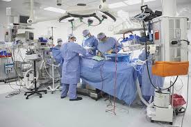 Surgeons Performing Surgery In Operating Room Hospital Interior Design Operating Room Hospital Interior