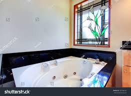 bathroom white whirlpool tub black tile