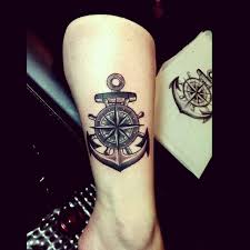 This compass tattoo is inked on alongside an anchor, portraying two very important aspects of life. Compass Tattoo Tattoos Tattoos For Guys