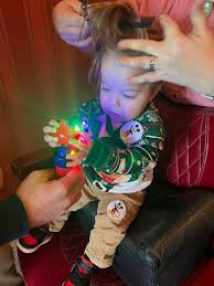 10/10 suggest the First Haircut experience at Harmony Barber Shop! It  includes a Mickey hat and a certificate. Some back story… My son was born  with a TON of hair, and it