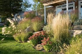 How To Design A Great Garden On A Sloped Lot Ornamental Grass Landscape Farmhouse Landscaping Sloped Garden