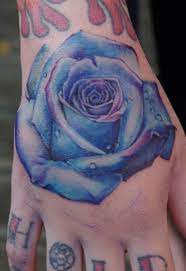 Electric Blue And Realistic Rose Tattoo Done On A Hand Realistic Rose Tattoo Tattoos Rose Tattoo