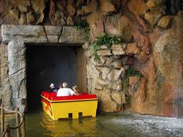 Boats travel on a long winding river through a dinosaur infested jungle, with caves, dynamic waterfalls and erupting geysers. Photo Ride Report Jurassic Jungle Boat Ride Theme Parks Roller Coasters Donkeys Theme Park Review