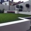 Green grass growth between cement walkway. 1
