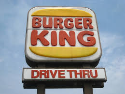 The logo is a picture of a king sitting on top of a hamburger holding a soda. Old Burger King Logos