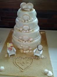 Simple beach themed weding cake, top tier rich fruit, bottom chocolate mud decorated with hand modelled shells, starfish and of course the beach deck chairs and thongs. Coolest Homemade Beach Scene Cakes