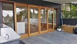 centre opening timber sliding doors stacking externally over wall with glass louvre sidelights for ve timber sliding doors sliding doors outdoor house colors