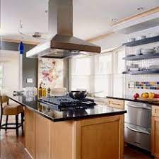 White and brown cottage kitchen charmed with a brown center island topped with white quartz in front of a cooktop designed with a white and wood trim vent hood. 24 Best Kitchen Island Hood Fans Ideas Kitchen Design Kitchen Island Hood