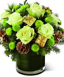 This Glass Cylinder Is Filled With Holiday Presents Fresh Winter Roses And Green Bu Christmas Flower Arrangements Fresh Flowers Arrangements Christmas Flowers