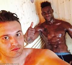 Liverpool striker Mario Balotelli works up a sweat in a sauna with best  friend