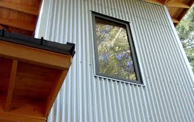 A galvanized garden shed sided with corrugated panels salvaged from old chicken coops in napa valley sits poolside in a st. Durable Metal Siding Products Poco Building Supplies