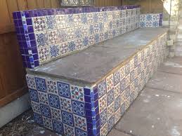 Animal pottery, birdbaths, spheres, square pots, pot with handles and more. Mexican Tiles Grouted Onto A Concrete Bench In The Garden Mexican Tile Fireplace Decor Mexican Tile Art