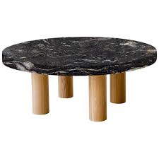 They are an ideal place where you can rest and take your coffee while watching a movie. Round Cosmic Black Coffee Table With Circular Oak Legs