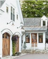 Black And White House With Wood Garage Door This House Has The Perfect Storm Of Elements Black Windows Wood Doors Metal Roof Whitepaint A Modern Farmhouse Exterior Farmhouse Exterior House Exterior