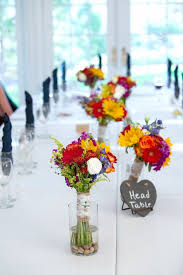 Vases painted white for wedding head table for bridesmaid bouquets. Bouquet Reception Table Decor