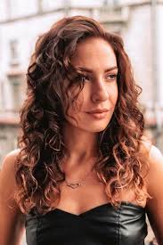 Some short layered curly hair is perfect for creating this voluminous and posh look. Implement Curly Bangs In Your Outlook And Enjoy The Flattering Effect