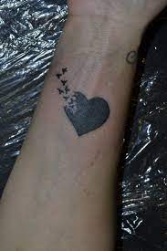 Westend Tattoo Westendtattooandpiercing Tattoo Small Tattoo Small Black Heart Tattoo With Bird Tetovalas Ki Black Bird Tattoo Small Tattoos Heart Tattoo