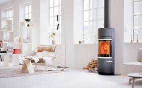 Iron fireplace like a stove in a house with fire, scandinavian interior modern design, white room. Scan Danish Wood Burning Stoves Modern Design