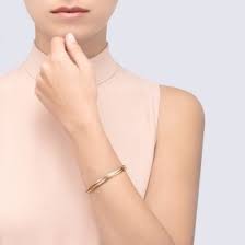 Decorated with small screws, the bracelet is available in yellow, grey or red gold. Trinity Bracelet Trinity Bracelet Small Model 18k White Gold 18k Pink Gold 18k Yellow Gold Width 2 8mm Trinity Bracelet Gold Bangles Design Cartier Trinity Bracelet