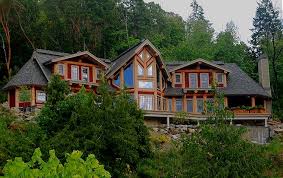 Post and beam construction uses glulam beams or natural timber placed on vertical posts to create expansive living spaces. Post Beam Log Homes Log Joinery Timber Frame Construction Traditional Log Styles Bc Alberta Saskatchewan Quebec Canada United States