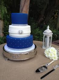 Ice blue wedding cake by rachels cakes via flickr change the colors to plum purple and blood red. Three Tier Fondant Wedding Cake Royal Blue And White With Bling Ribbon And A Silver Broach Ht Royal Blue Wedding Cakes Royal Blue Cake Silver Winter Wedding