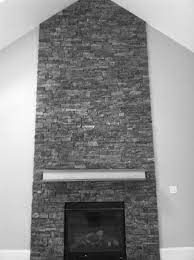 Amazing gallery of interior design and decorating ideas of black stone fireplace hearth in bedrooms, living rooms, decks/patios, kitchens by elite interior chic living room features a dark gray velvet sofa lined with a black and white geometric pillow and a gold dots pillow facing a pair of side by side light. Most Recent Free Blue Stone Fireplace Style Stacked Stone Fireplaces Are Undeniably Gorgeous And C Grey Stone Fireplace Stone Fireplace Natural Stone Fireplace
