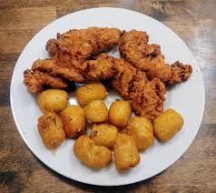 Using tongs, slowly add breaded tenders into oil. Homemade Buttermilk Brined Fried Chicken Tenders And Tater Tots Food