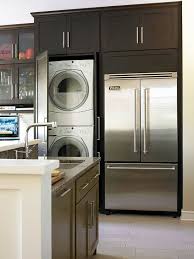 The washers and dryers offer flexible installation possibilities, and only one electrical outlet is needed since the washer plugs into the dryer. Combining Rooms Purposes And Periods Was A Tall Order But Smart Style And Storage Bring The Re Laundry In Kitchen Kitchen Design Small Kitchen Remodel Small