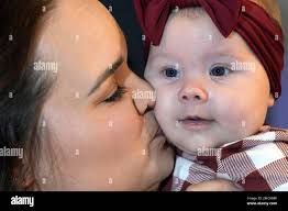 Kelsey Wright kisses her 4-month-old daughter, Berklee,