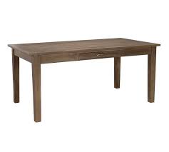 Grooves and saw marks create the look of salvaged lumber, and oversized bolts on the legs and surface add to its historic style. Arrington Dining Table Pottery Barn