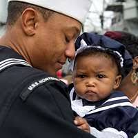 Lt. Adam Cowan congratulates his wife, Lt. j.g. Amber Cowan, assigned to  the Blue crew of the ballistic missile submarine USS Maine (SSBN 741),  after pinning