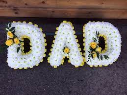 Funeral name flowers near me. A Dad Tribute Edged With Yellow Ribbon And With Yellow Rose Sprays Funeral Flowers Flower Names Yellow Roses