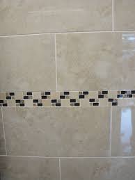 Most commonly in the form of wall or backsplash tile in kitchens and bathrooms, they can be made from all sorts of materials, such as ceramic, travertine, glass, porcelain, mirror, slate and marble. Coventry Bathrooms Cream And Brown Wall Tiles With Mosaic Tile Border