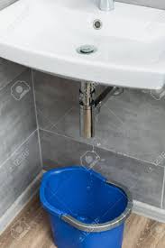 damaged sink pipe with water drops and