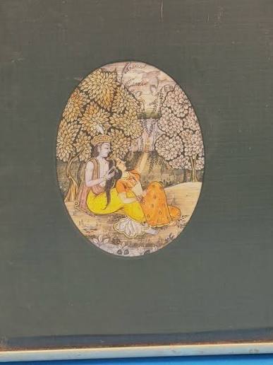 A Rajasthani or Pahari miniature painting — likely Krishna and Radha in a garden. Oval composition, gold leaf trees, hand-painted on paper or old manuscript. Style looks like 19th–early 20th century. #IndianMiniaturePainting #