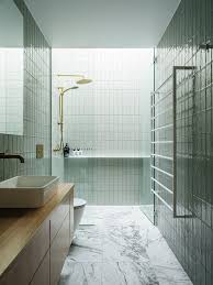 White Tile Clad Bathroom With Brass Tapware And A Skylight Hobart Tasmania Australia In 2020 White Tiles Skylight Bathroom Interior Design