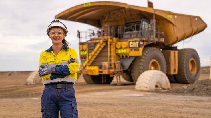 Mining professional with heavy equipment at an active site
