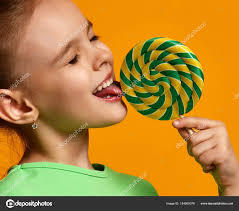 Happy young little child girl kid bite sweet lollypop candy — Stock Photo ©  dml5050 #184669376