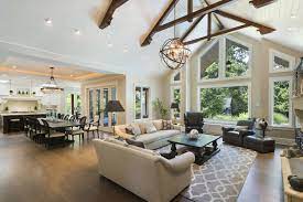 Light wood ceiling beams contrast with the room's dark gray walls and rich blue floor. The Right Way To Craft A Chic Open Concept Space Open Living Room Design Open Living Room Living Room Remodel