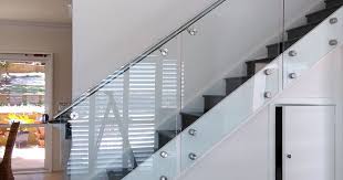 Smoked glass balustrade with brass clamps & oak. Frameless Glass Balustrade Melbourne Glass Balcony Balustrades