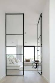 Gorgeous Minimalist Interior With White Walls And Black Steel Frame Doors Minimalism Interior Minimalist Home House Interior