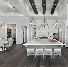 Rustic white painted beams in the ceiling of this living room designed by martyn lawrence bullard is softened up by the crystal chandelier. All White Kitchen With Black Ceiling Beams On We Heart It