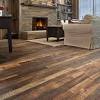 The room also features rustic hardwood floors with a vaulted ceiling lighted by a. 1
