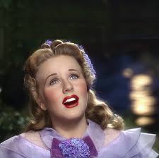 A couple of stills from 1944's "Can't Help Singing" . Deanna with Robert  Paige has the original promo copy