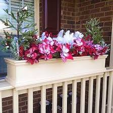 Each flower box requires two brackets to distribute the you can hold a flower box in place on top or on the side of a railing and wrap it with two lengths chain or rope a few inches inward from each end of the box. Winter Window Box Ideas Railing Flower Boxes Deck Railing Planters Railing Planters