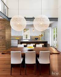 Modern White Dining Room With Spherical Light Fixtures White Dining Room Modern Dining Room Lighting Dining Room Lighting