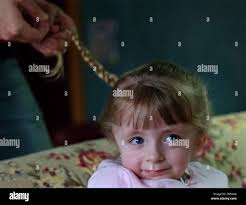 Apr 07, 2006; International Falls, MN, USA; Five-year-old Hope Moss has her  hair braided for school by her personal care assistant, Danni Kallerman.  Moss is attending kindergarten at Falls Elementary School. Kallerman,