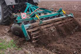 Tractor Pulling A Plow Plowing A Field Stock Photo Picture And Royalty Free Image Image 56528510