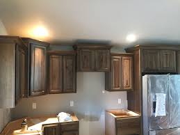 Dark stain on the cabinets provides a warmer, more inviting feel for the kitchen. Dark Stain Hickory Cabinets With Crown Moulding Stained Kitchen Cabinets Hickory Kitchen Cabinets Hickory Cabinets